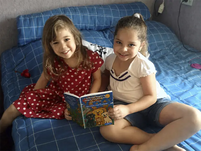 Criança lendo um livro da coleção Mundo Mágico